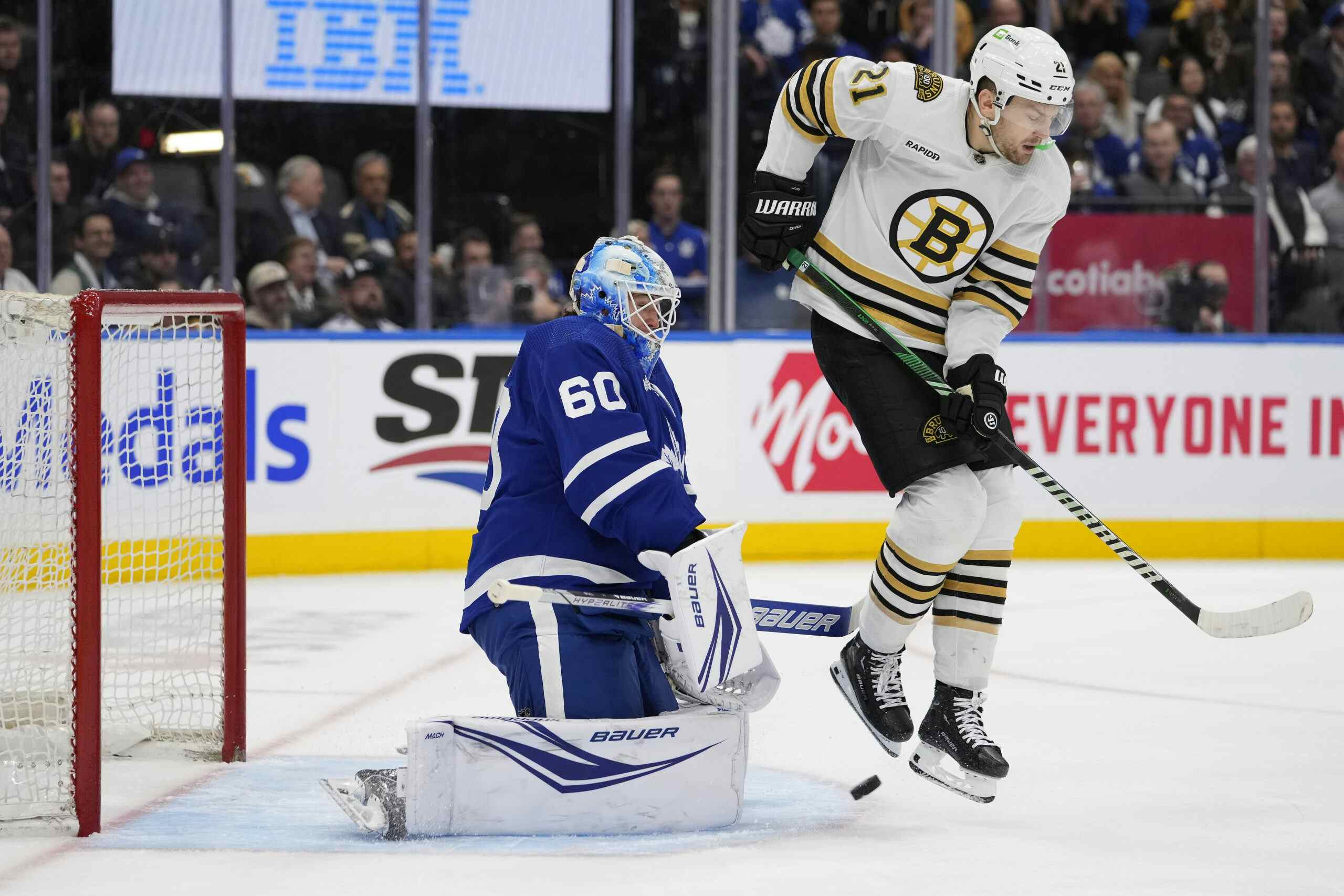 Boston Bruins forward James van Riemsdyk screens Maple Leafs goalie Joseph Woll.