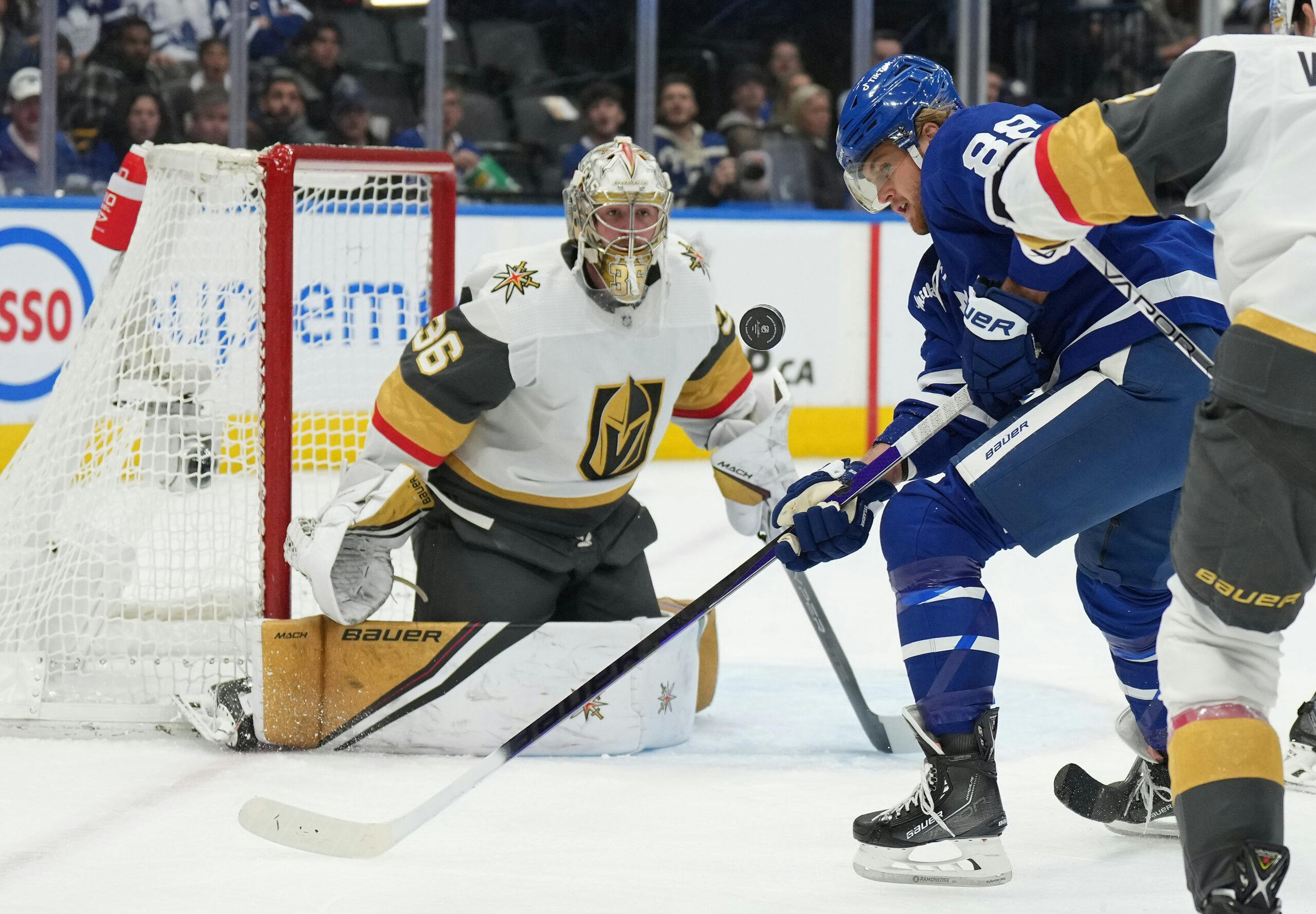 Goaltender Logan Thompson makes a save on William Nylander of the Toronto Maple Leafs.