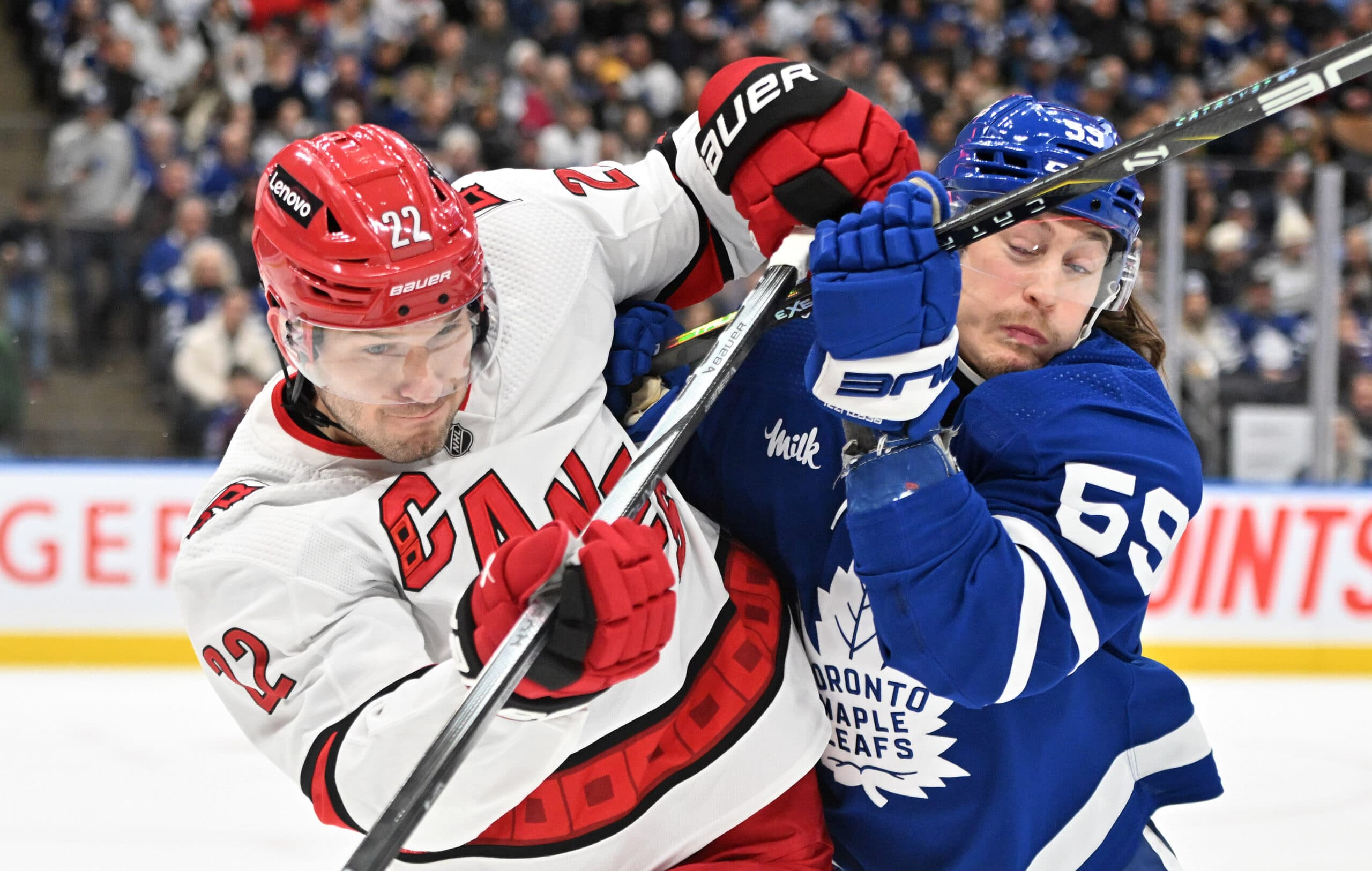 Carolina Hurricanes defenseman Brett Pesce battles Tyler Bertuzzi of the Toronto Maple Leafs.