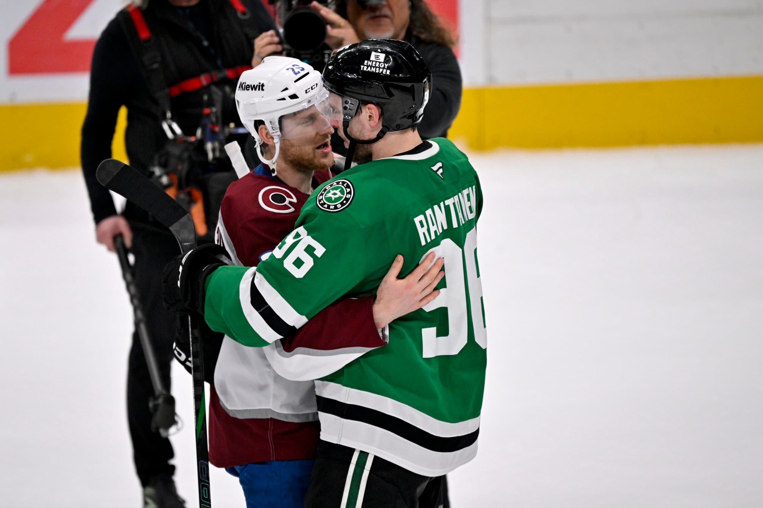 Colorado Avalanche forward Nathan MacKinnon hugs ex-teammate Mikko Rantanen after the Dallas Stars eliminated the Avs in seven games.
