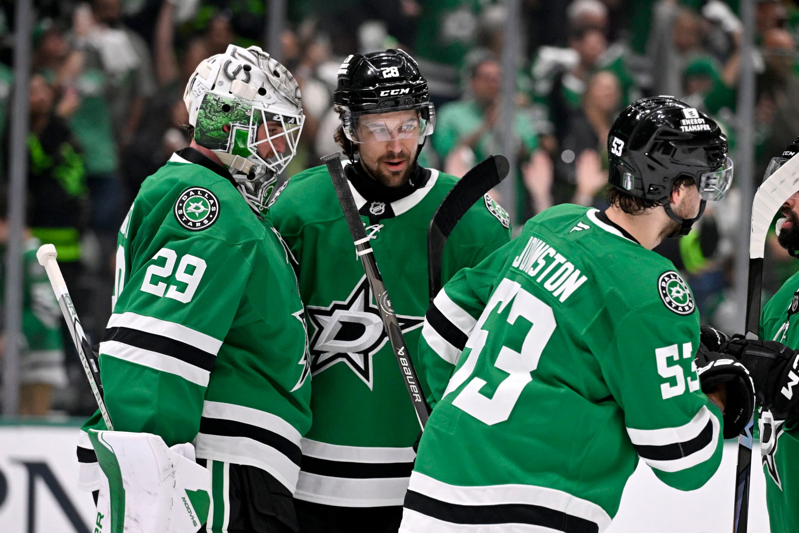 Dallas Stars Wyatt Johnston, Jake Oettinger, and Alex Petrovic celebrate after a Game 3 win over the Winnipeg Jets.