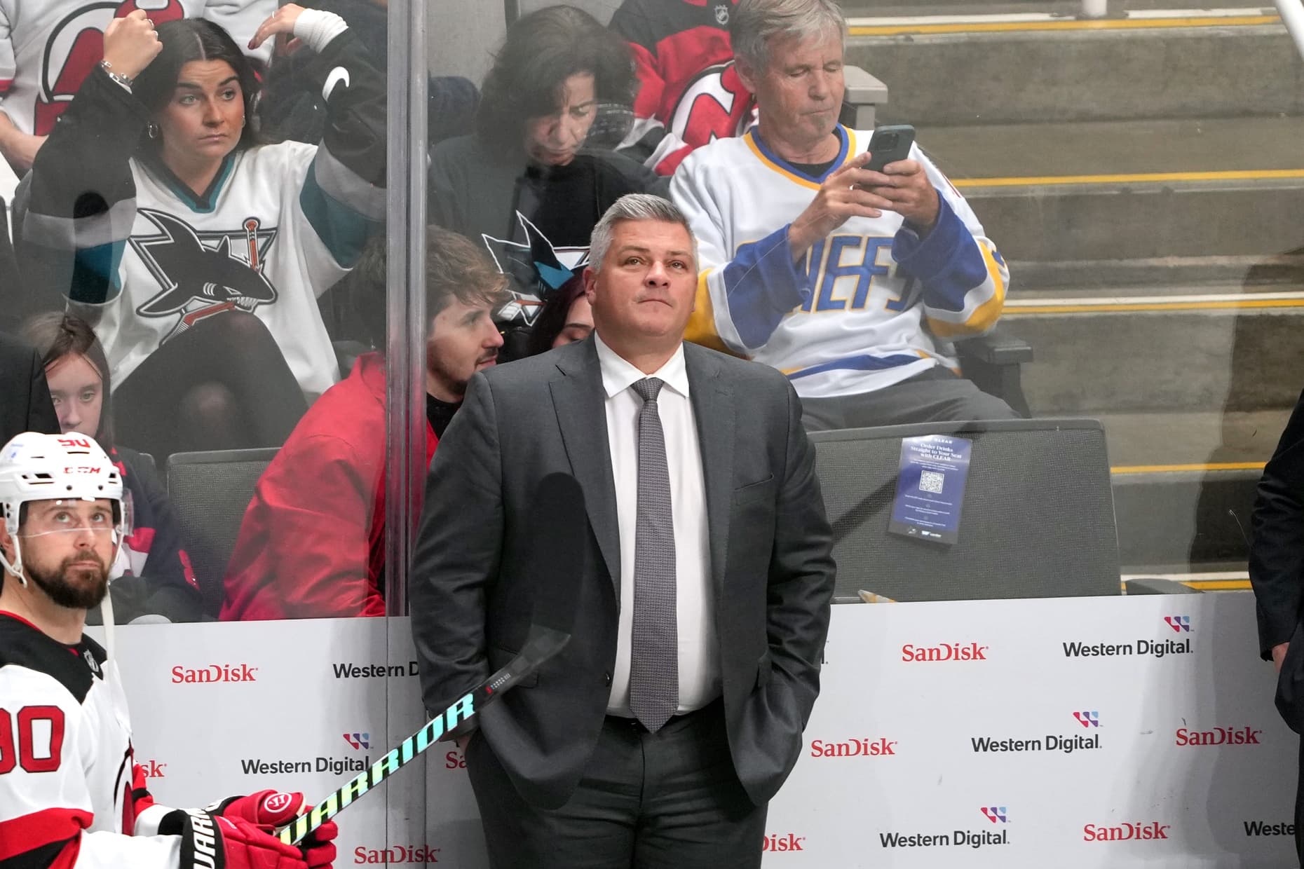 New Jersey Devils head coach Sheldon Keefe (center) stands behind the bench before the start of the third period against the San Jose Sharks at SAP Center at San Jose.